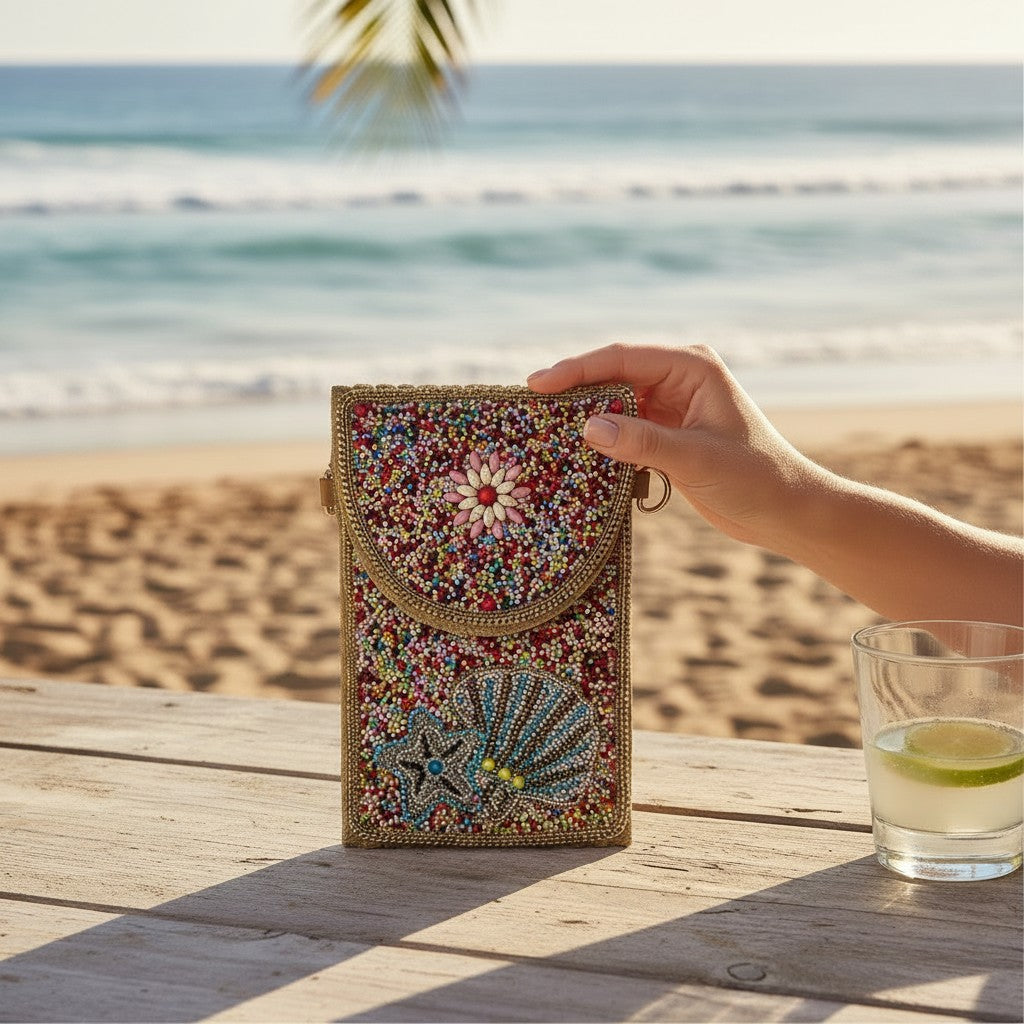 L and B Creations beaded envelope clutch with seashell and starfish motifs, featuring a detachable crossbody strap.