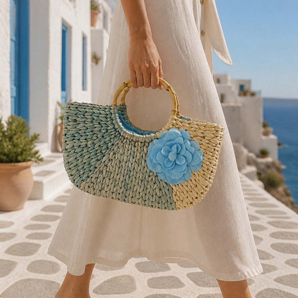 L and B Creations braided twine handbag with blue flower detail and bamboo handles held by a woman in a white dress.