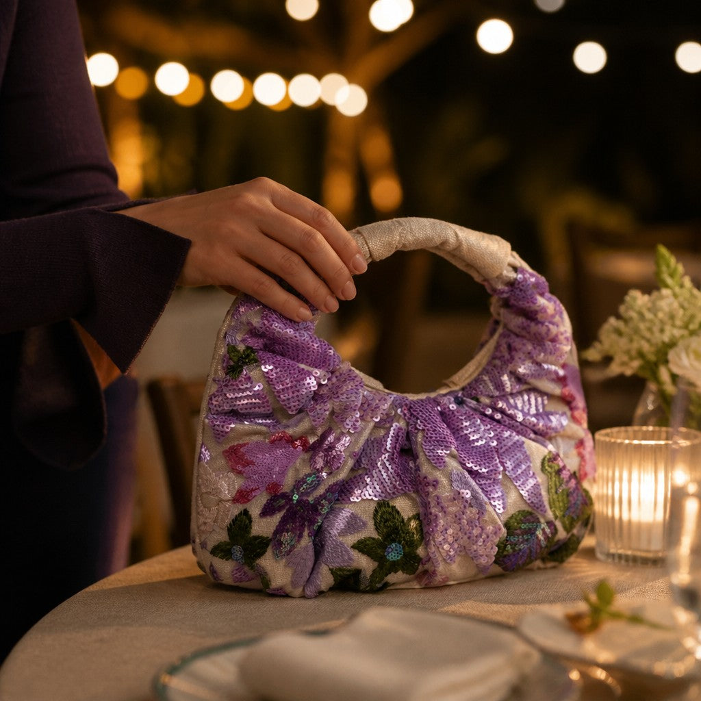 L and B Creations flower sequin scrunch handbag with purple floral embroidery and cream interior on a table.