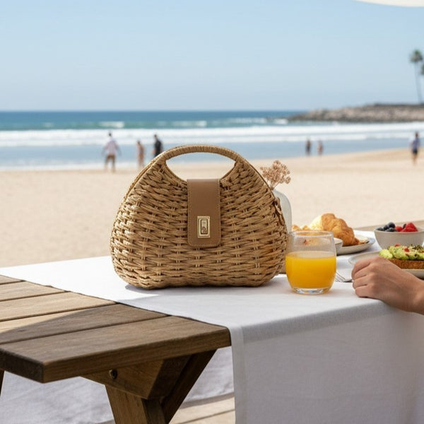L and B Creations magnetic twine handbag with light brown leather details and crossbody strap on a beachside table.