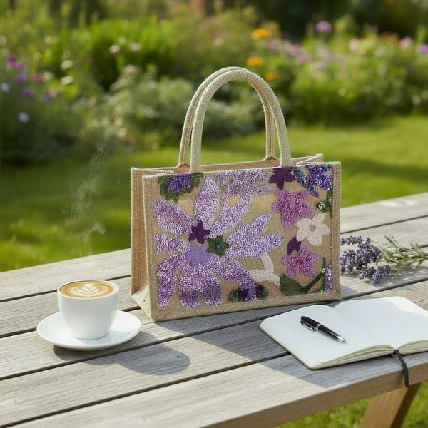 L and B Creations mid-size canvas tote bag featuring purple and green sequin flower embroidery on a rustic jute base.